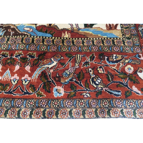 102 - AN EASTERN SILK CREAM GROUND RUG DEPICTING A HUNTING SCENE