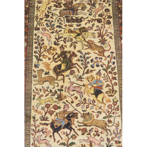 102 - AN EASTERN SILK CREAM GROUND RUG DEPICTING A HUNTING SCENE