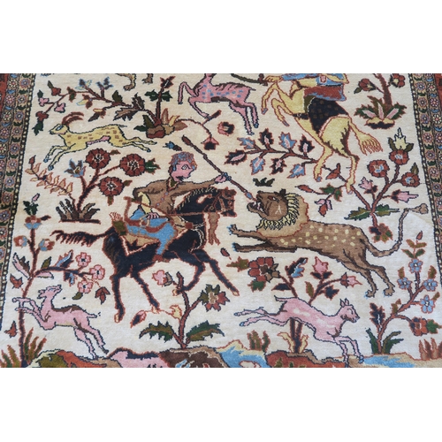 102 - AN EASTERN SILK CREAM GROUND RUG DEPICTING A HUNTING SCENE