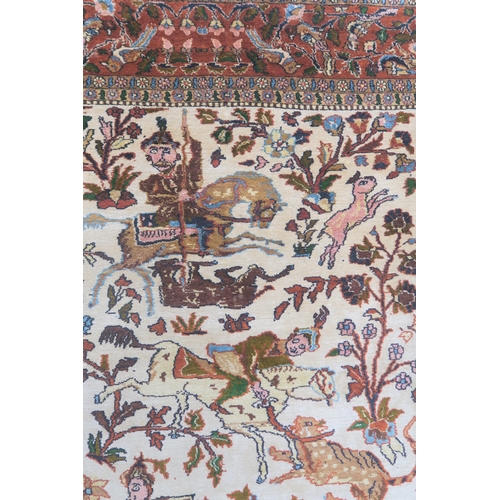 102 - AN EASTERN SILK CREAM GROUND RUG DEPICTING A HUNTING SCENE