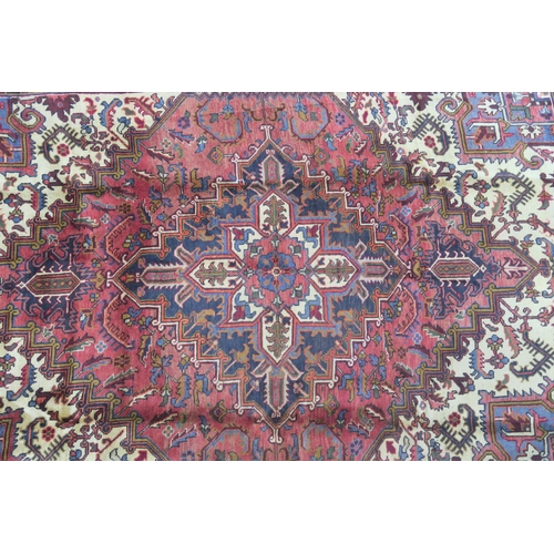 106 - A CREAM AND TERRACOTTA GROUND HERIZ RUG