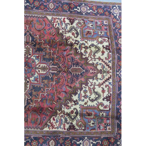 106 - A CREAM AND TERRACOTTA GROUND HERIZ RUG