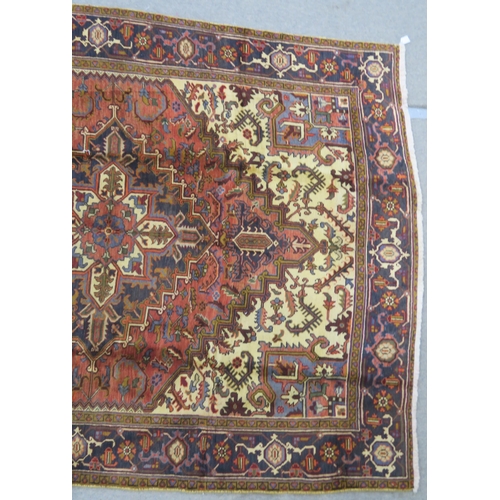 106 - A CREAM AND TERRACOTTA GROUND HERIZ RUG