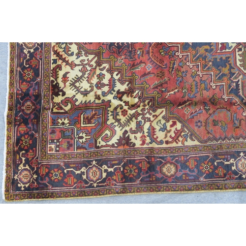 106 - A CREAM AND TERRACOTTA GROUND HERIZ RUG