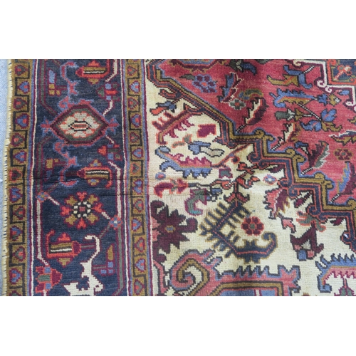 106 - A CREAM AND TERRACOTTA GROUND HERIZ RUG