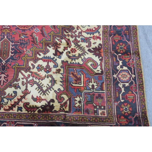 106 - A CREAM AND TERRACOTTA GROUND HERIZ RUG