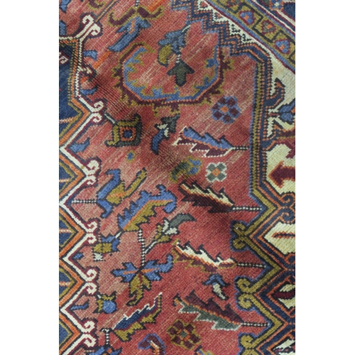 106 - A CREAM AND TERRACOTTA GROUND HERIZ RUG