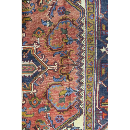 106 - A CREAM AND TERRACOTTA GROUND HERIZ RUG