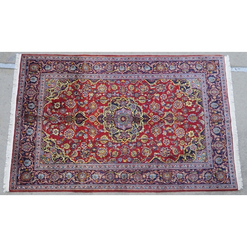 107 - A RED GROUND FINE KASHAN RUG