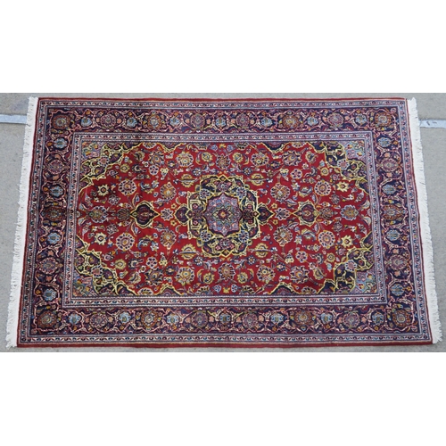 107 - A RED GROUND FINE KASHAN RUG