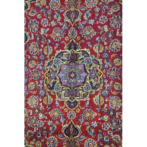 107 - A RED GROUND FINE KASHAN RUG