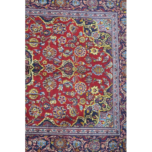 107 - A RED GROUND FINE KASHAN RUG