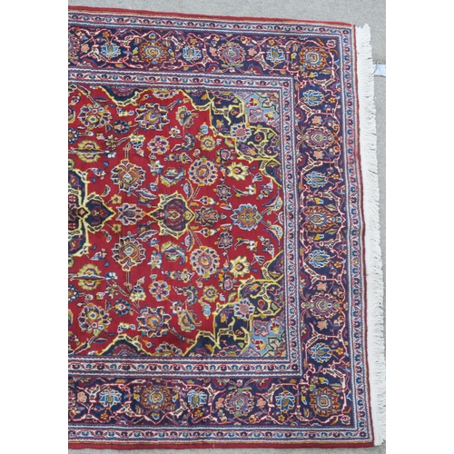 107 - A RED GROUND FINE KASHAN RUG