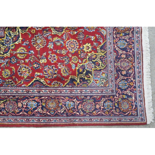 107 - A RED GROUND FINE KASHAN RUG