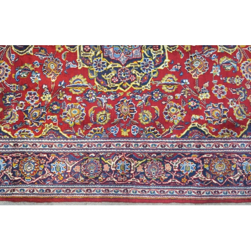 107 - A RED GROUND FINE KASHAN RUG