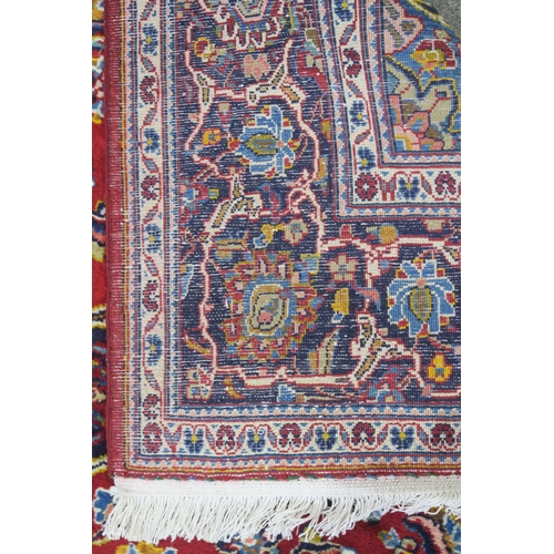 107 - A RED GROUND FINE KASHAN RUG