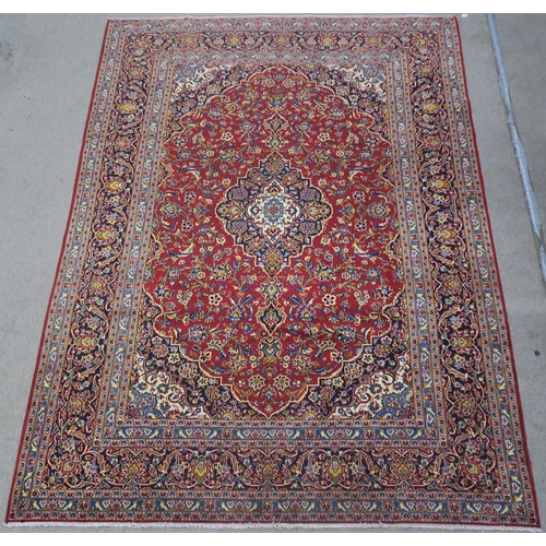 108 - A RED GROUND FINE KESHAN RUG