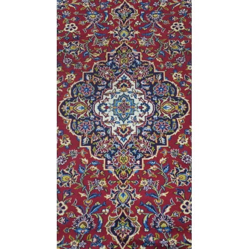 108 - A RED GROUND FINE KESHAN RUG