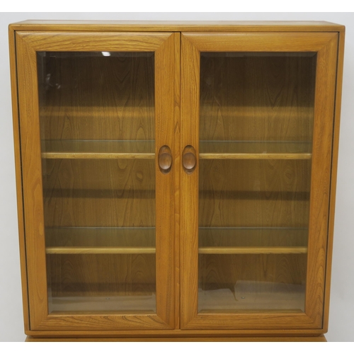 137 - AN ELM ERCOL 2149 DISPLAY CABINET ON CUPBOARD BASE