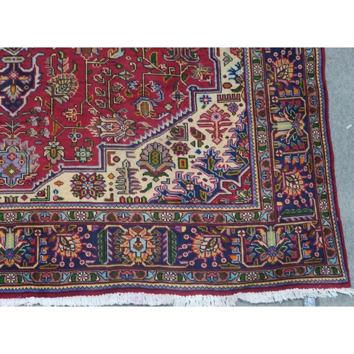 106 - A RED GROUND TABRIZ RUG