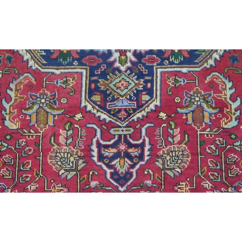 106 - A RED GROUND TABRIZ RUG