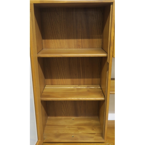 115 - AN ERCOL WINDSOR WALL DISPLAY UNIT