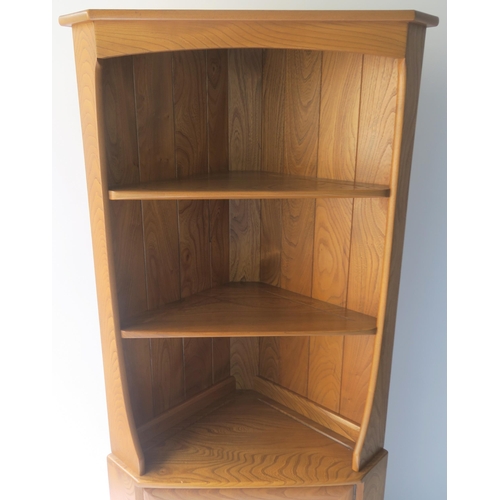 116 - AN ERCOL CORNER CABINET