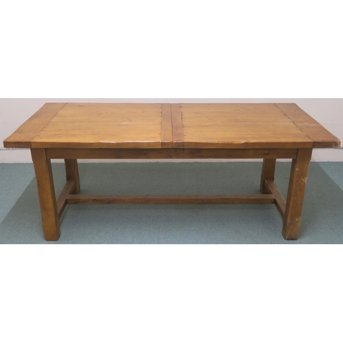 128A - A LARGE OAK EXTENDING DINING TABLE