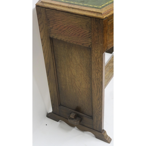 61 - A COTSWOLD SCHOOL OAK DESK WITH GREEN LEATHER SKIVER