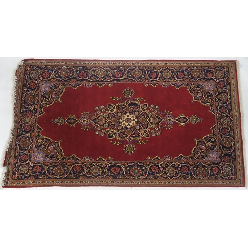 99 - A RED GROUND FINE KESHAN RUG