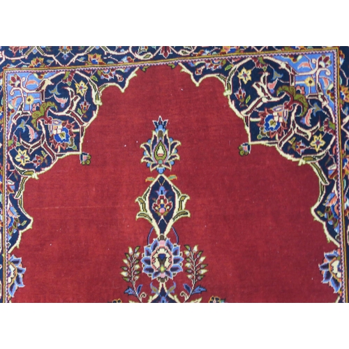 99 - A RED GROUND FINE KESHAN RUG