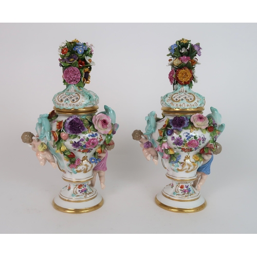 268 - A PAIR OF MEISSEN STYLE FLORAL ENCRUSTED VASES AND COVERS