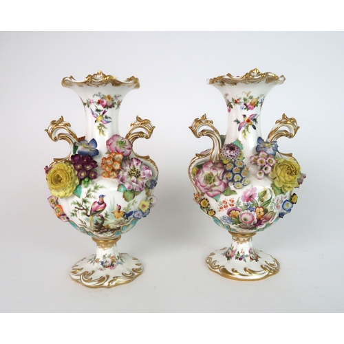 274 - A PAIR OF CONTINENTAL FLORAL ENCRUSTED TWO HANDLED VASES