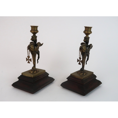 311 - A PAIR OF BRASS GRIFFIN CANDLESTICKS