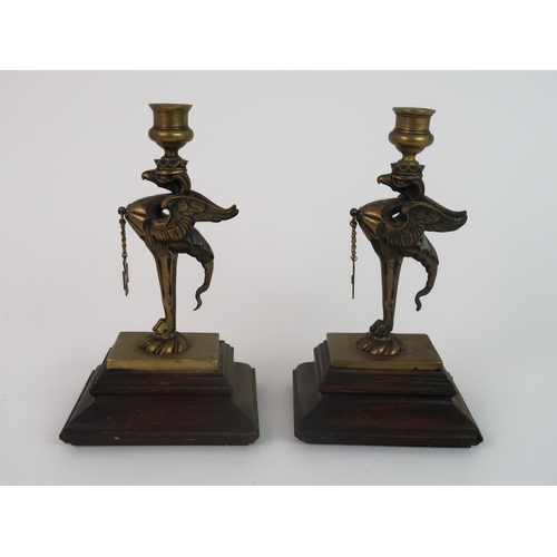 311 - A PAIR OF BRASS GRIFFIN CANDLESTICKS