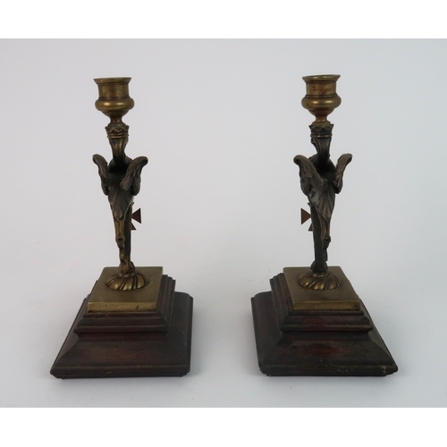 311 - A PAIR OF BRASS GRIFFIN CANDLESTICKS