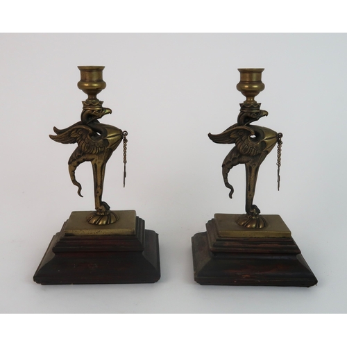 311 - A PAIR OF BRASS GRIFFIN CANDLESTICKS