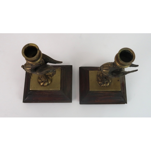 311 - A PAIR OF BRASS GRIFFIN CANDLESTICKS