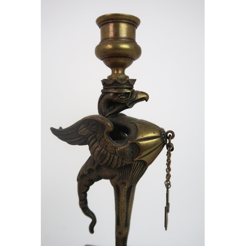 311 - A PAIR OF BRASS GRIFFIN CANDLESTICKS