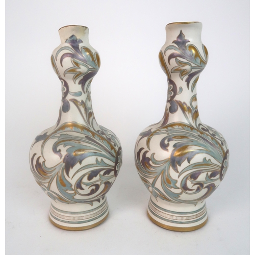 312 - A PAIR OF ROYAL DOULTON CARRARA WARE EWERS