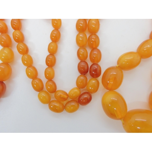 507 - TWO STRINGS OF AMBER BEADS