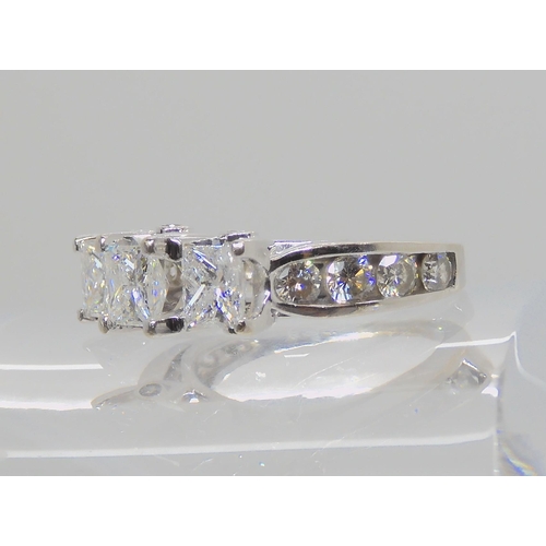 514 - A 14K WHITE GOLD PRINCESS CUT THREE STONE RING