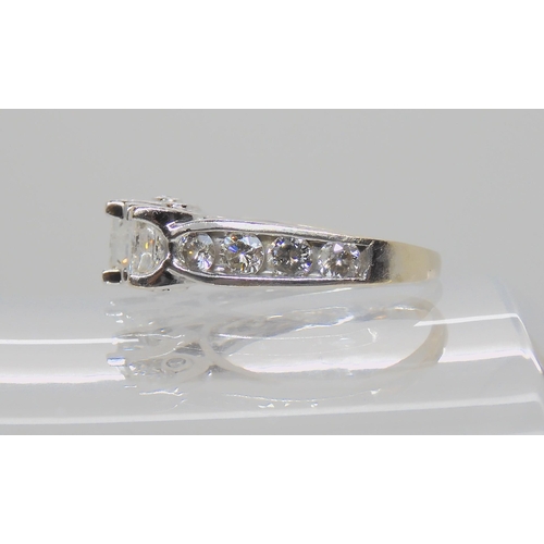 514 - A 14K WHITE GOLD PRINCESS CUT THREE STONE RING