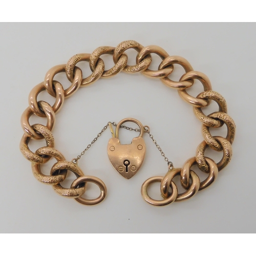 515 - A 9CT ROSE GOLD CURB LINK BRACELET WITH ENGRAVED DETAIL