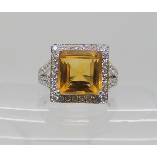 523 - A PLATINUM DIAMOND AND CITRINE DRESS RING