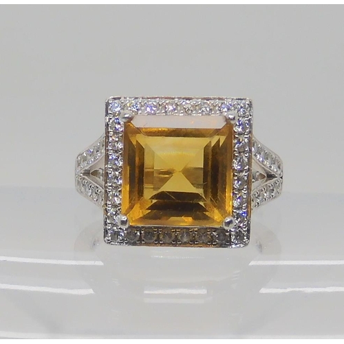 523 - A PLATINUM DIAMOND AND CITRINE DRESS RING