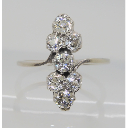 524 - AN ART DECO SEVEN STONE CLUSTER RING