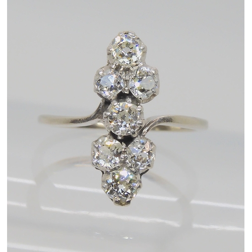 524 - AN ART DECO SEVEN STONE CLUSTER RING