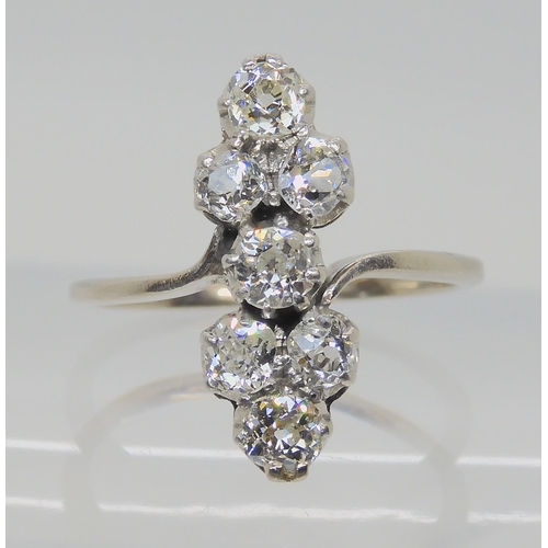 524 - AN ART DECO SEVEN STONE CLUSTER RING