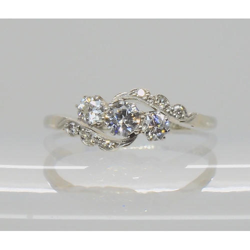 526 - AN 18CT WHITE GOLD AND PLATINUM THREE STONE DIAMOND RING